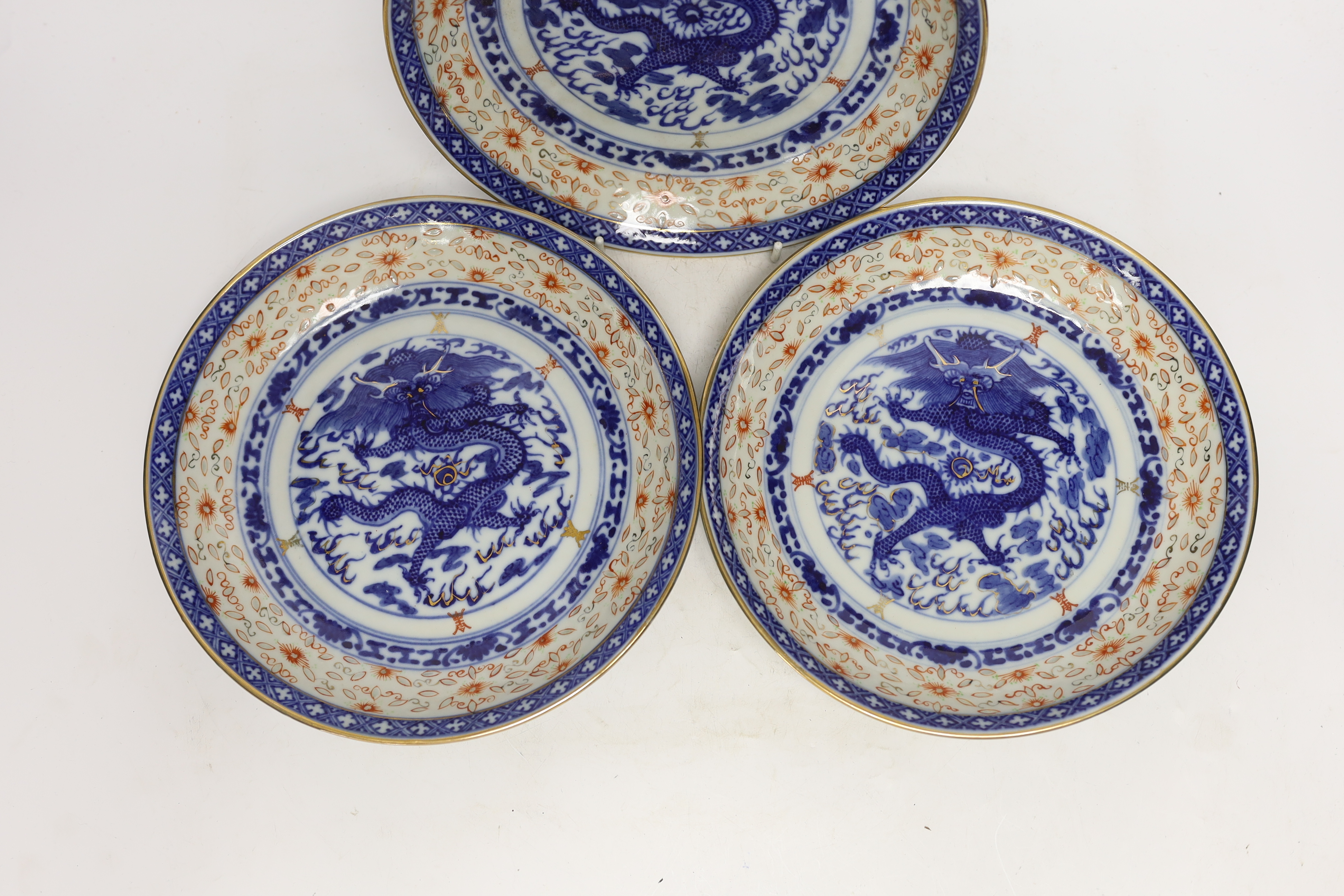 Three Chinese blue and white ‘dragon’ dishes, 24cm diameter